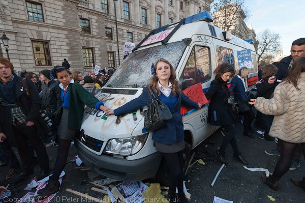 Schoolgirls try to protect police van at student demonstration, Nov 2010, by Peter Marshall